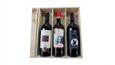 Three varieties of Red Wine from Bello Winery placed in a wood b